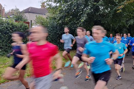 runners flash past the camera