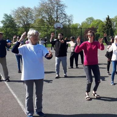 a group of people doing tai chi