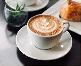 cup of cappucino and cakes