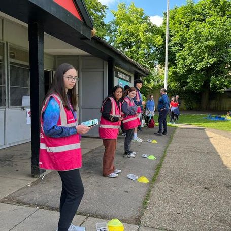a line of volunteers waiting to scan finish tokens