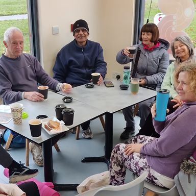a group of people sitting drinking coffee